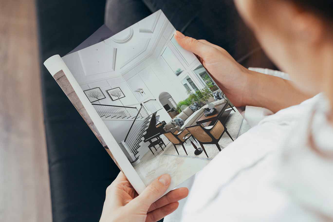 Person-holding-brochure-of-custom-homes-guide